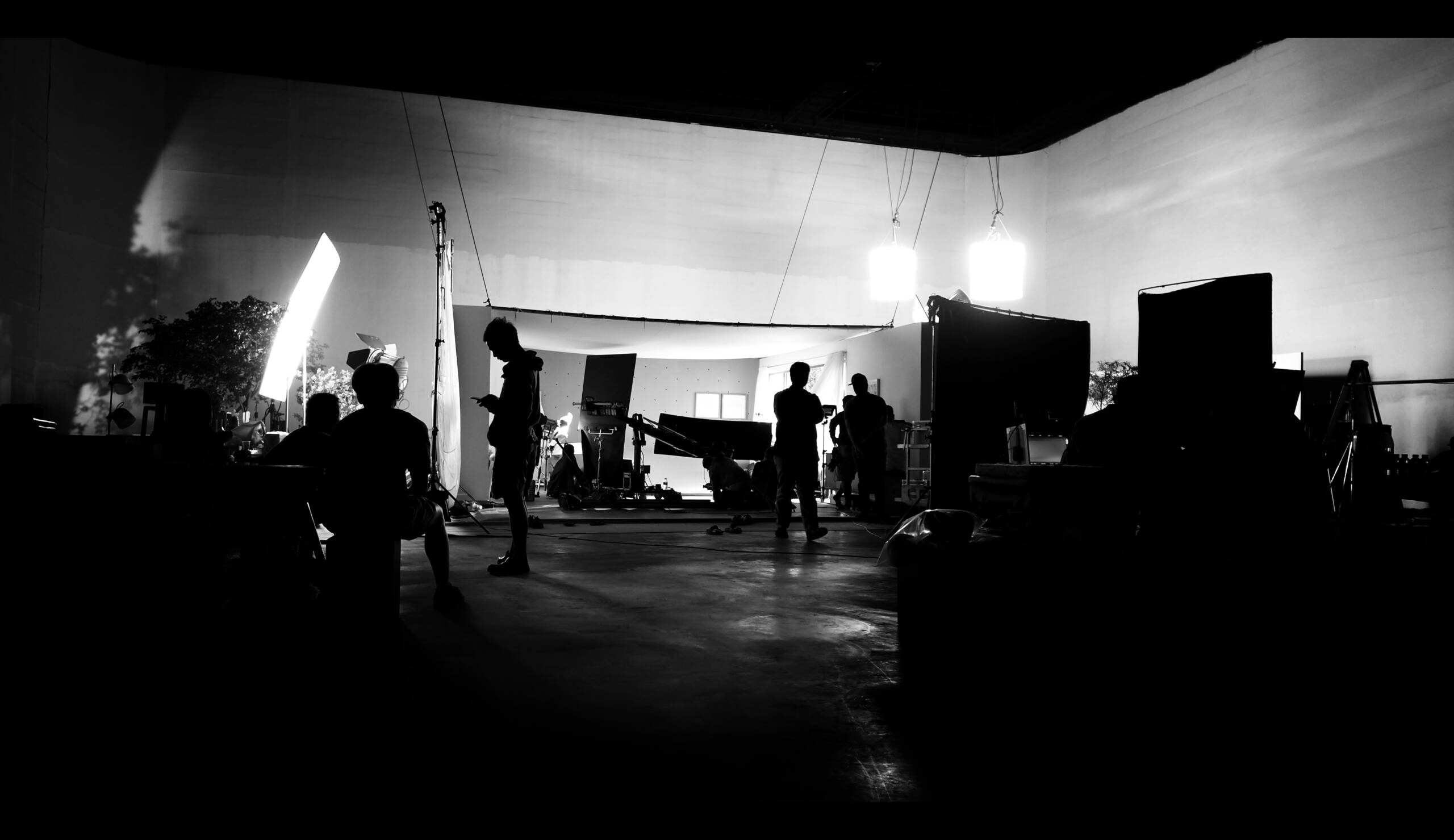 Silhoutte images of video production and lighting set for filming which movie crew team working and